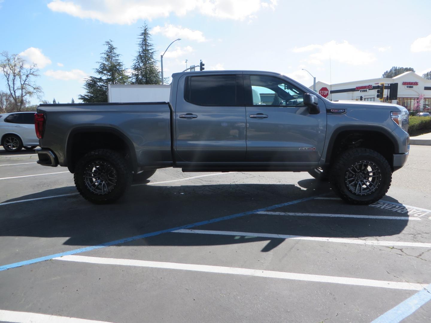 2019 CHARCOAL /BLACK GMC Sierra 1500 AT4 Crew Cab Long Box 4WD (1GTP9EEL6KZ) with an 6.2L V8 OHV 16V engine, 6A transmission, located at 2630 Grass Valley Highway, Auburn, CA, 95603, (530) 508-5100, 38.937893, -121.095482 - Dont miss this AT4 featuring a 4" RC lift kit kit, 35" Nitto Ridge Grappler tires, 20" Fuel Rebel wheels, Amp POwer steps, Air Bags, and a Tyger Bed cover. - Photo#3